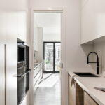 Caesarstone® Mineral Cloudburst Concrete™ Oak_Orange_pantry_1.jpg