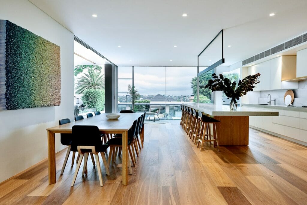 island kitchen design with wooden floors and white benchtop