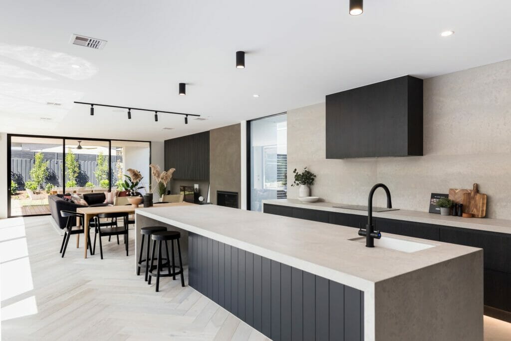 Caesarstone kitchen with grey benchtop, black tapware, and black furniture.