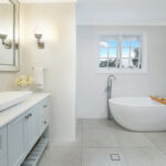Freestanding bathtup in bathroom with white vanity benchtop
