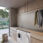 Caesarstone porcelain benchtop 550 Silvax, laundry washing machine and dryer, sink, gold tapware, hanging clothes and washing basket