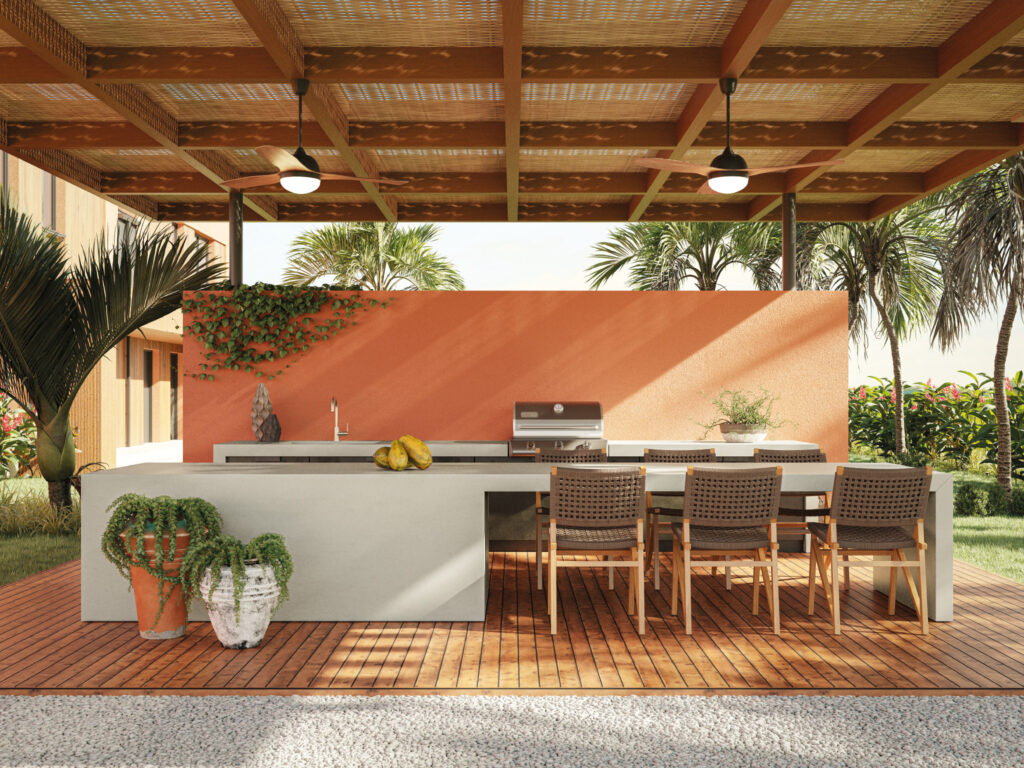 Outdoor kitchen space with Porcelain benchtop surfaces, with warm orange hues and wood accents
