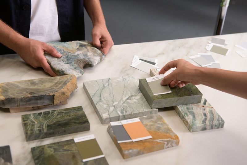 Designers matching colour paint swatches with samples of mineral and porcelain slabs