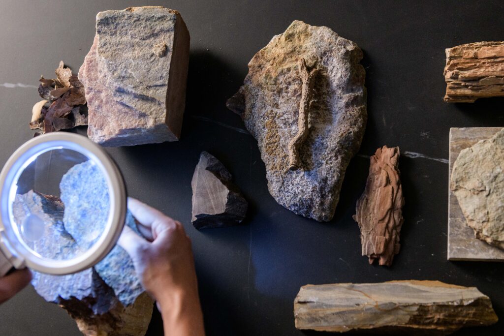 Closely inspecting the elements of natural stones with a handheld light to draw inspiration