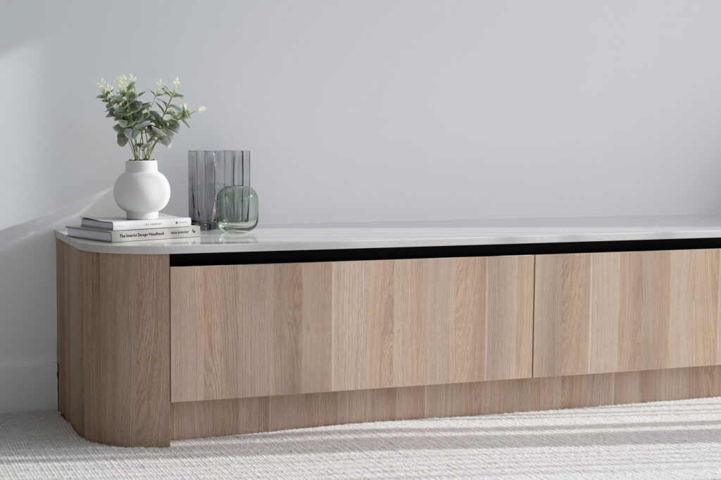Contemporary TV unit with soft timber cabinetry topped with a crisp white Caesarstone® surface.