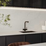Kitchenette featuring Caesarstone countertops, fluted timber cabinetry, and a light-reflective minimalist palette.