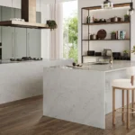 Modern kitchen layout with Caesarstone surface, muted deep green panelled cabinetry, and rich timber floors for a clean, tonal finish.