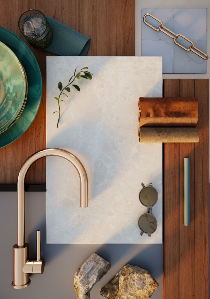 Flat lay moodboard using Caesarstone Porcelain with brushed bronze tapware, green ceramic plate, sunglasses and natural stone accents on a timber surface.