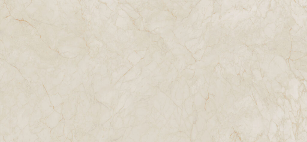 Caesarstone<sup>®</sup> Marbannova surface sample featuring a warm white base with soft gold, grey, and copper veining in a luxurious silk finish.
