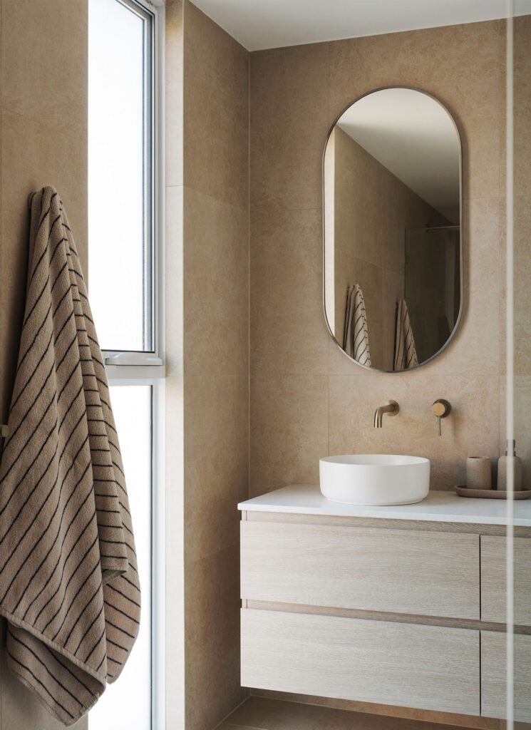 Modern coastal-inspired bathroom vanity with twin round basins, brushed nickel tapware, and Caesarstone<sup>®</sup> benchtop