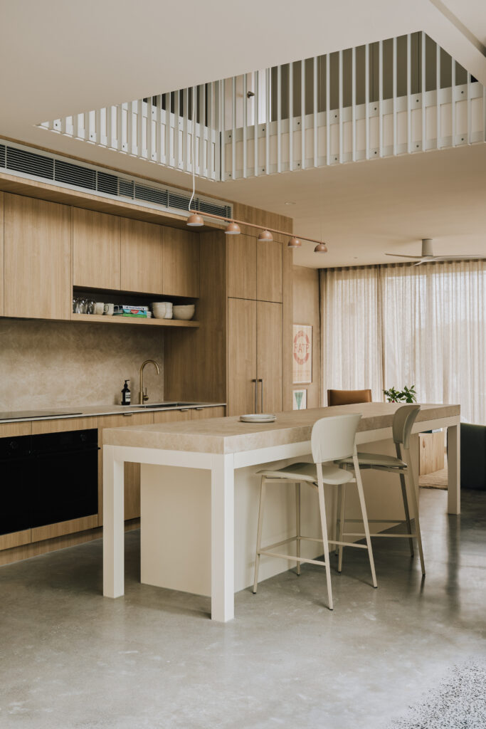 Modern kitchen featuring Caesarstone<sup>®</sup> Porcelain island benchtop with timber cabinetry and neutral finishes.