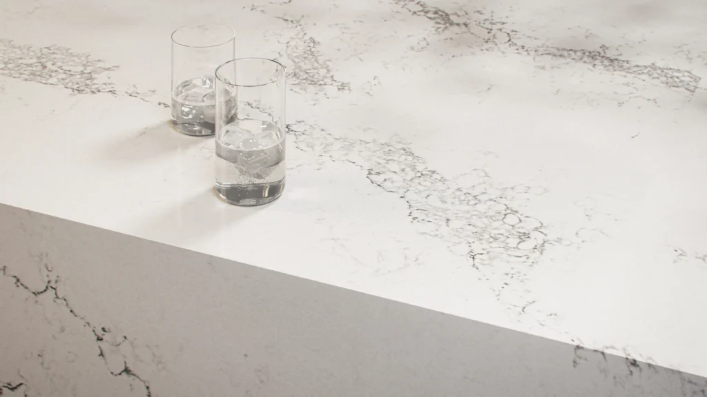 Caesarstone Statuario Maximus Mineral surface with two water glasses.