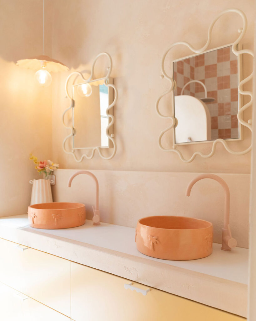 Porcelain bathroom vanity with peach ceramic basin and soft yellow cabinetry