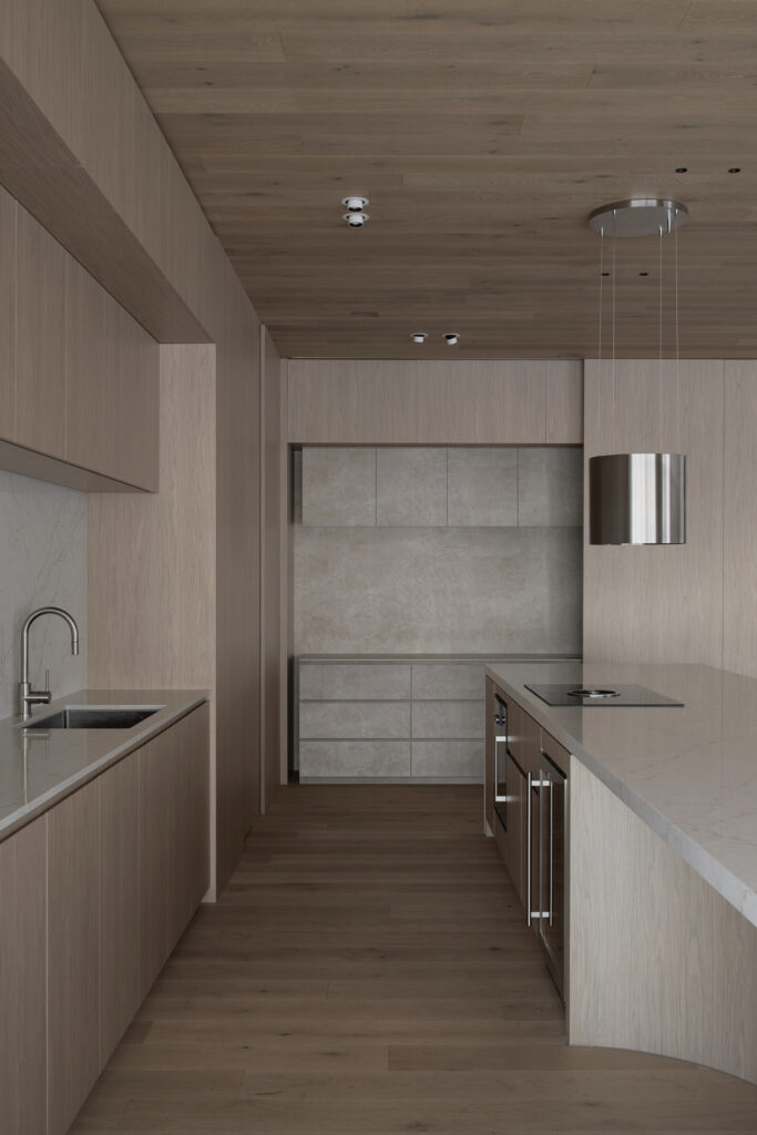 Kitchen installation inside Caesarstone’s Adelaide showroom showcasing Caesarstone<sup>®</sup> ICON™ and Caesarstone<sup>®</sup> Porcelain surfaces and warm timber cabinetry.