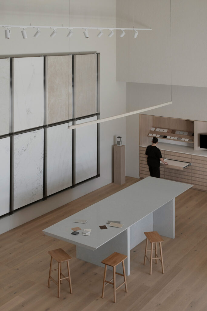 Large-format surface slab display and communal design island inside Caesarstone’s Adelaide flagship showroom in South Australia.