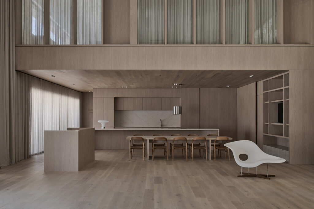 Contemporary kitchen display inside Caesarstone’s Adelaide flagship showroom featuring timber cabinetry and integrated Rossa Nova Caesarstone<sup>®</sup> ICON™ Advanced Mineral surface.