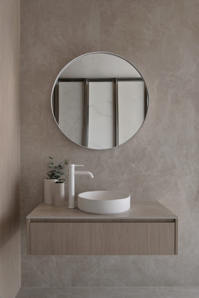 Bathroom vanity display inside Caesarstone’s Wingfield showroom in Adelaide featuring Caesarstone<sup>®</sup> Porcelain™ Fume surface with ABI Interiors basin and tapware.