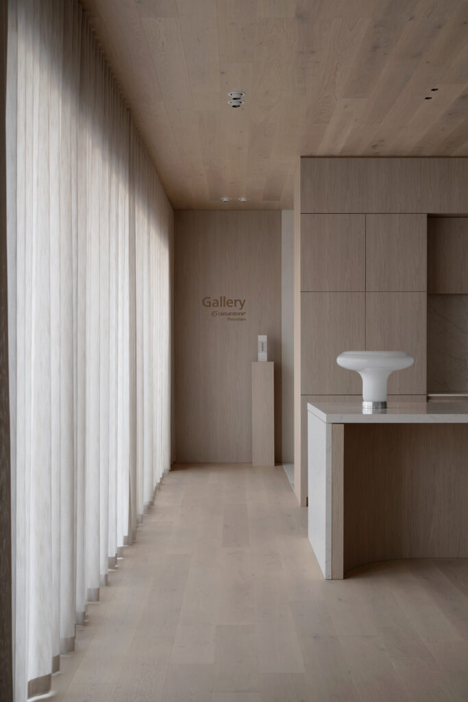 Gallery space inside Caesarstone’s Wingfield flagship showroom featuring timber-lined interiors and integrated mineral surface display.