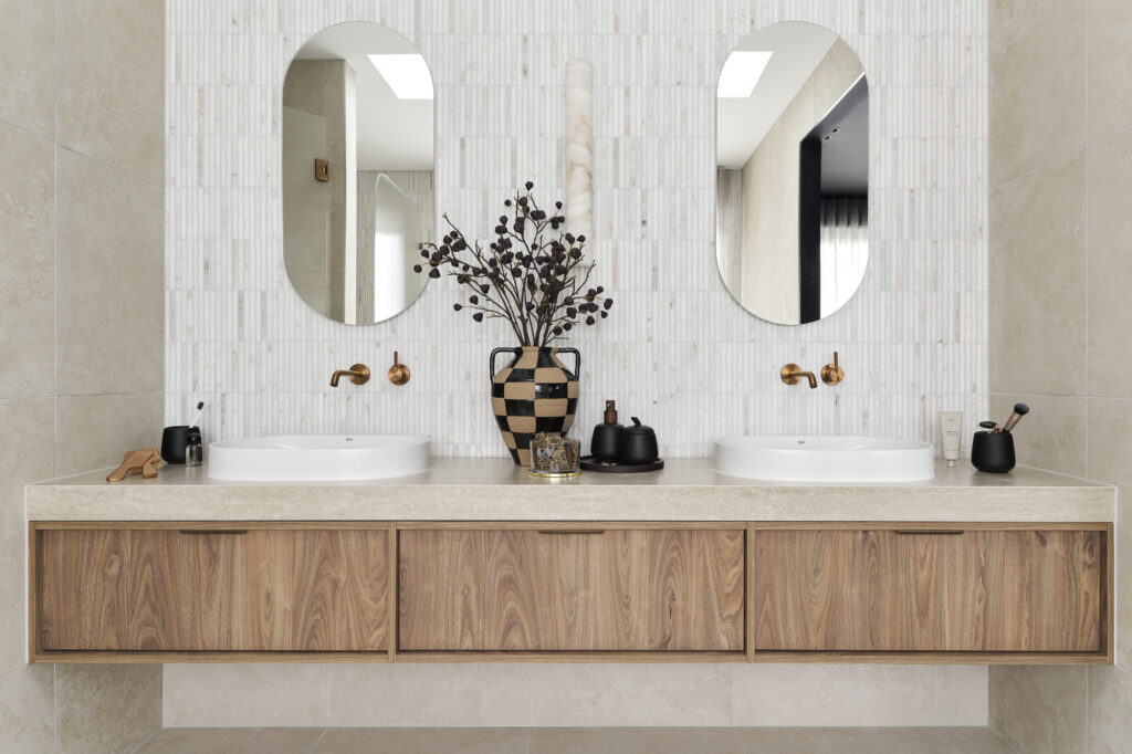 Bathroom vanity with Caesarstone Silvax Porcelain surface, 
vertical feature tiles and brushed bronze fittings
