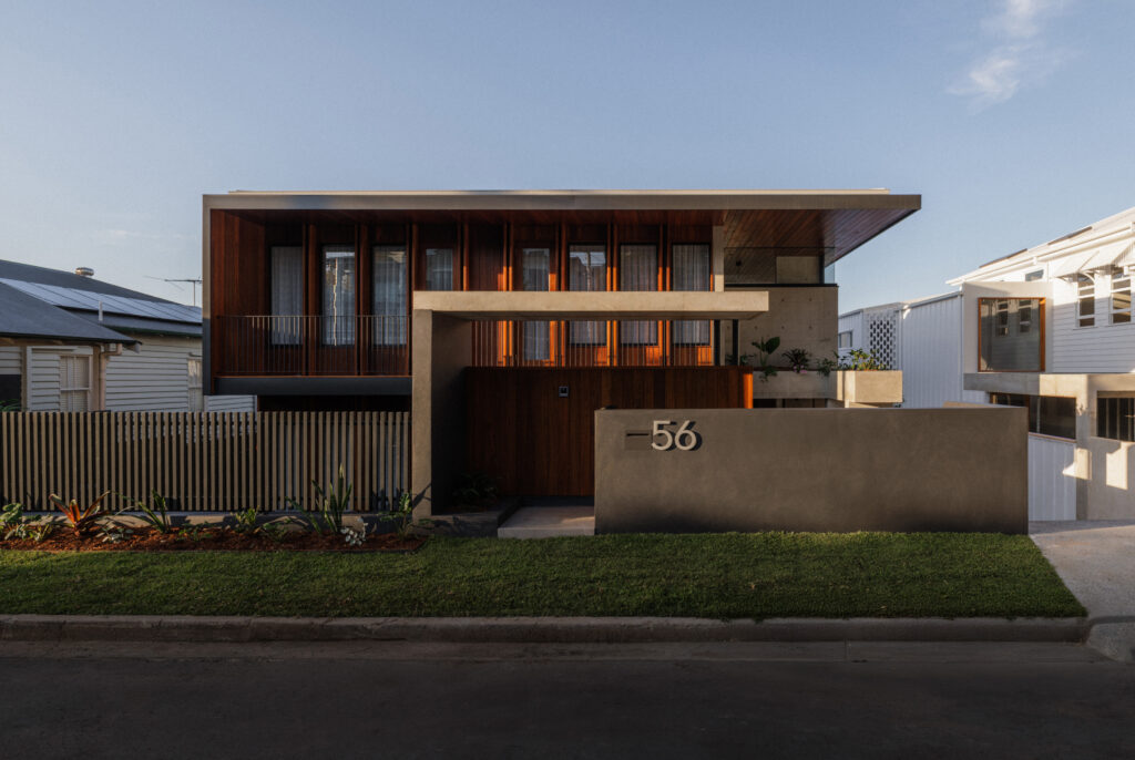 Exterior of 56 Novus by Sunstone Property Group showcasing concrete walls, timber cladding and contemporary architectural form in Brisbane