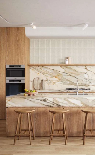 Caesarstone<sup>®</sup> Antikella™ 536 porcelain benchtop and full-height splashback with gold veining in contemporary kitchen with timber cabinetry and bar stools