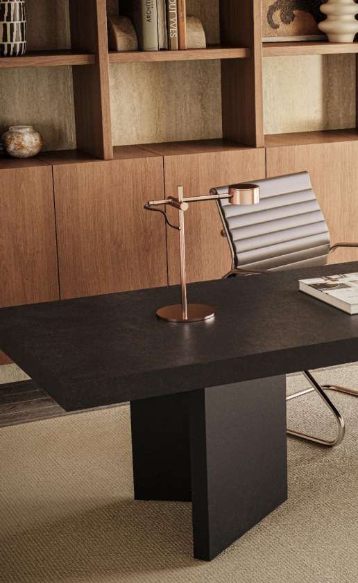 Caesarstone<sup>®</sup> Graphite Metal™ 311 porcelain dining table surface in architectural home office with timber shelving and industrial pendant lighting