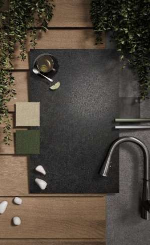 Caesarstone<sup>®</sup> Graphite Metal™ 311 porcelain surface swatch on design mood board with timber, stone and green colour samples and brushed steel tapware