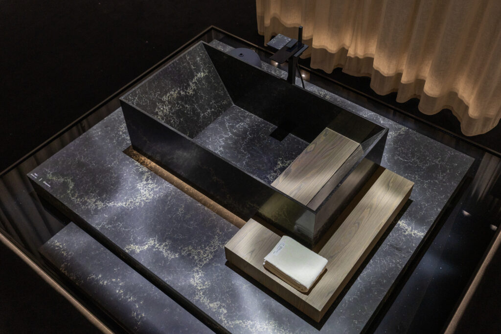 A monolithic bath form in Vanilla Noir creates a moment of stillness within the Aqua Sanctuary.
