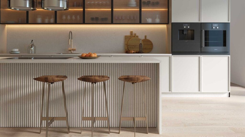 Minimalist kitchen with Caesarstone<sup>®</sup> mineral surface island, fluted detailing, warm lighting and integrated appliances
