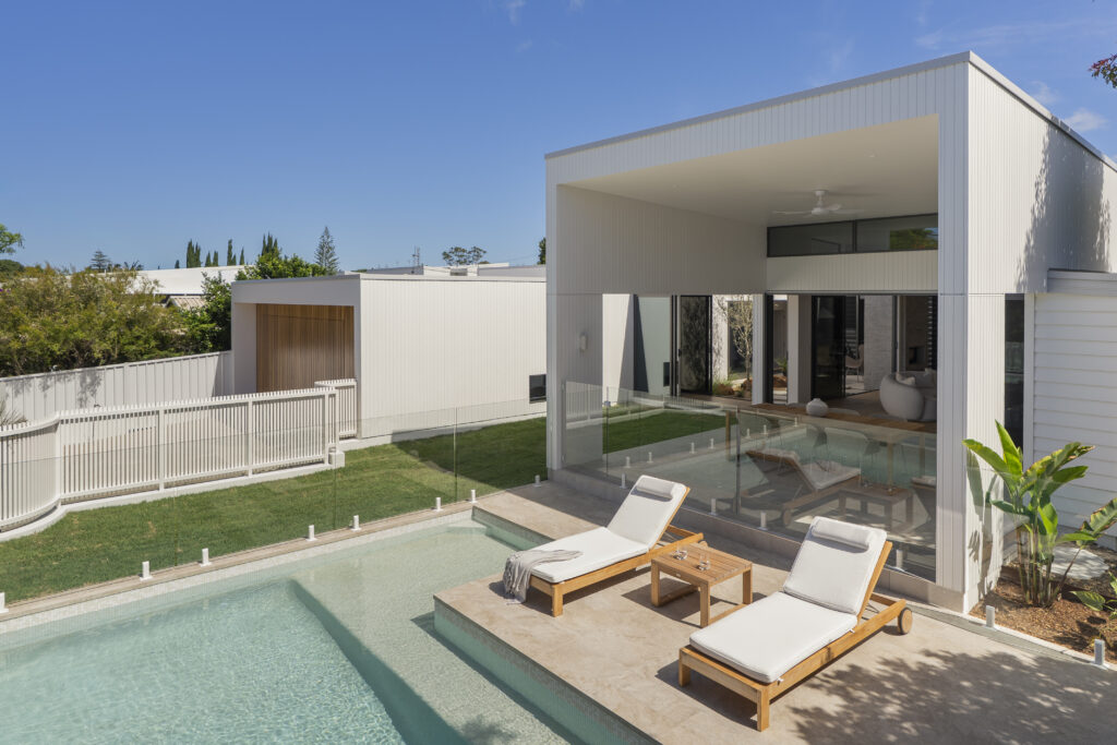 Outdoor pool and courtyard with covered alfresco area and seamless indoor outdoor connection