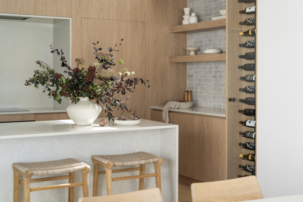 Open-plan kitchen and living space with natural light and layered materials