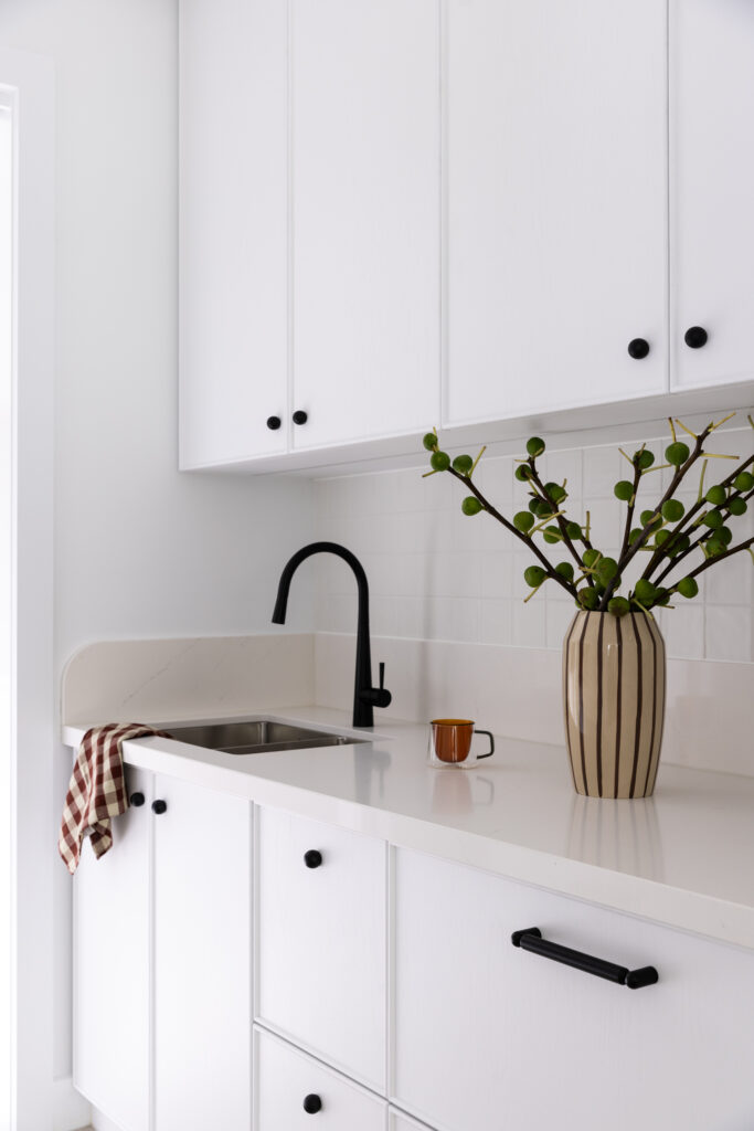 Aterra Blanca continues into the laundry, reinforcing a cohesive material palette throughout the home.