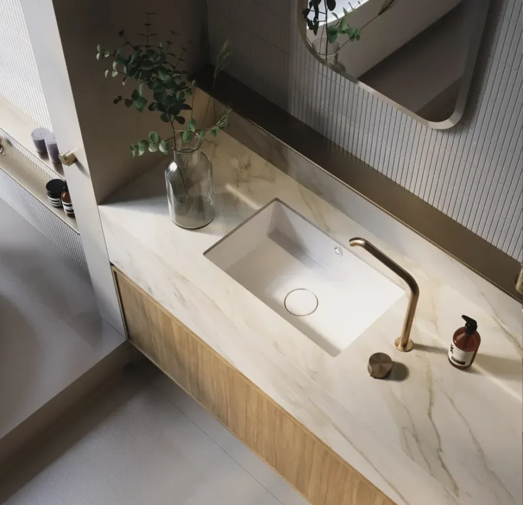 Porcelain vanity benchtop with soft marble veining, a square basin, copper tapware and timber cabinetry