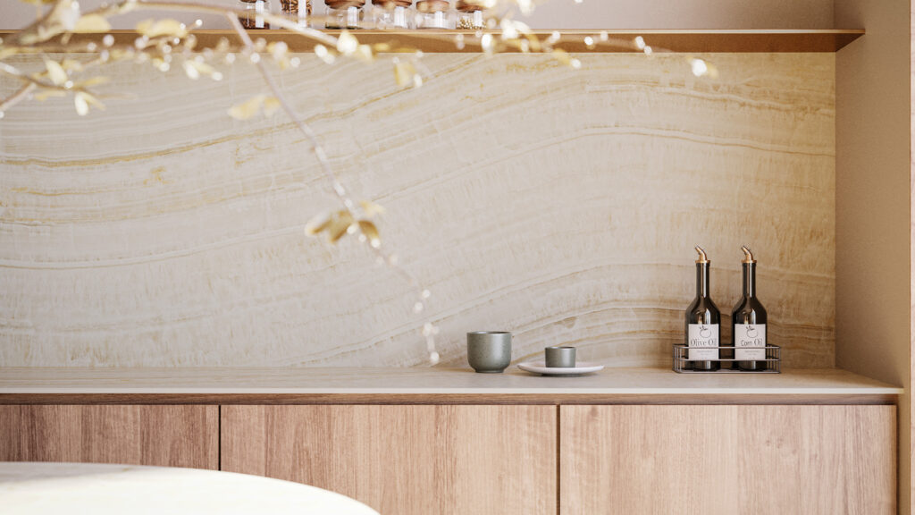 Caesartone porcelain splashback with warm, layered tones behind timber cabinetry, styled with a gold pendant light and glassware