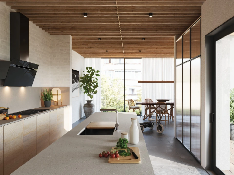 Contemporary kitchen with indoor-outdoor flow, Caesarstone<sup>®</sup> Raw Concrete island bench, timber slat ceiling and black cabinetry opening to an alfresco dining area.