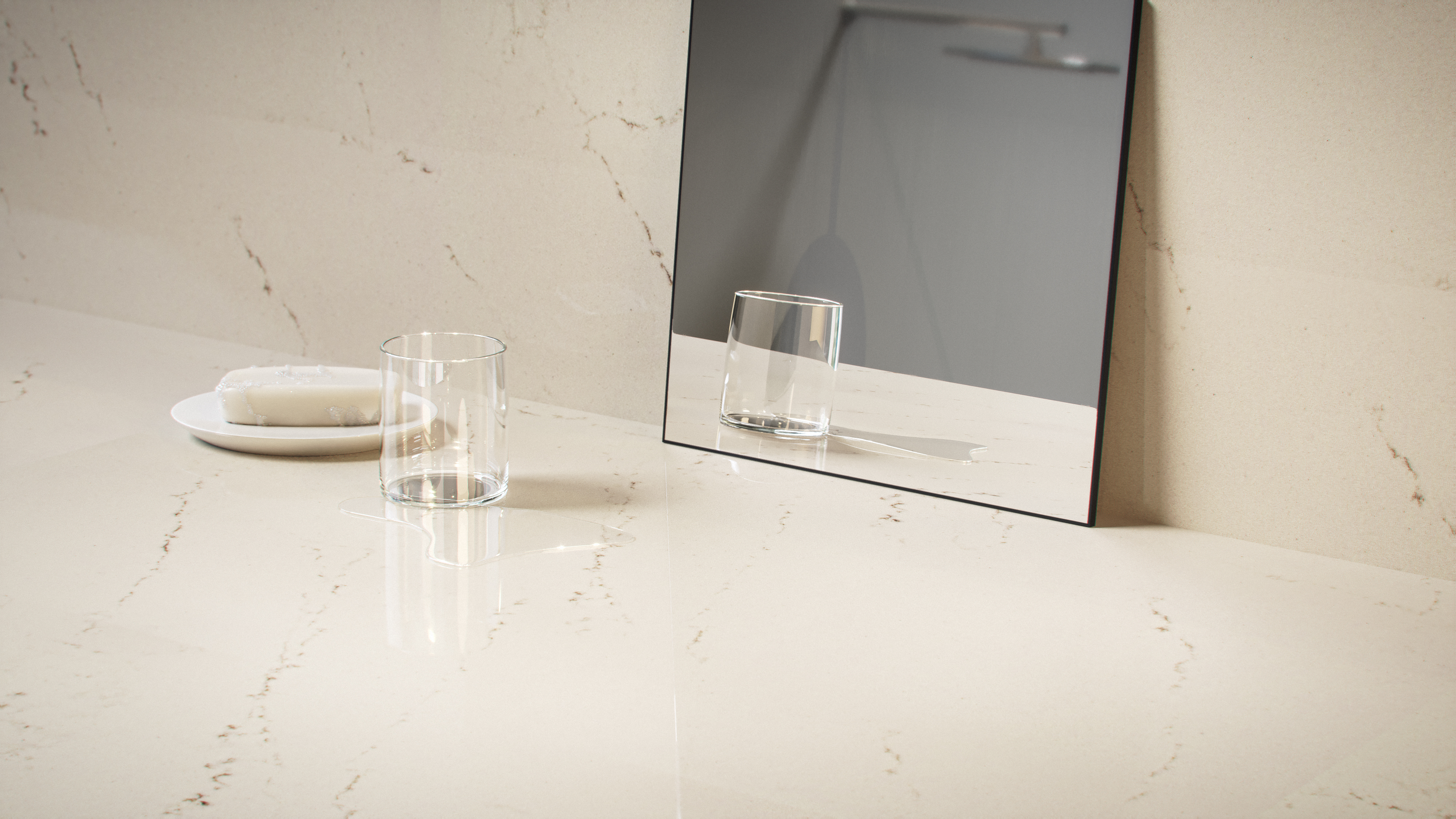 Water spill and soap next to a glass on a Caesarstone<sup>®</sup> Aterra Blanca bathroom vanity.